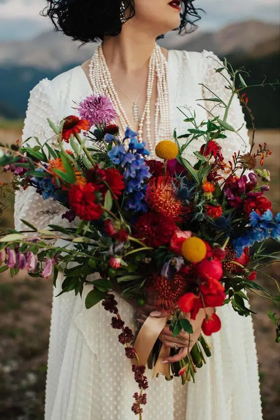 imgi_18_a-fantastic-jewel-tone-wedding-bouquet-with-red-orange-blue-lilac-blooms-greenery-billy-balls-and-much-texture.jpg imgi_18_a-fantastic-jewel-tone-wedding-bouquet-with-red-orange-blue-lilac-blooms-greenery-billy-balls-and-much-texture.jpg
